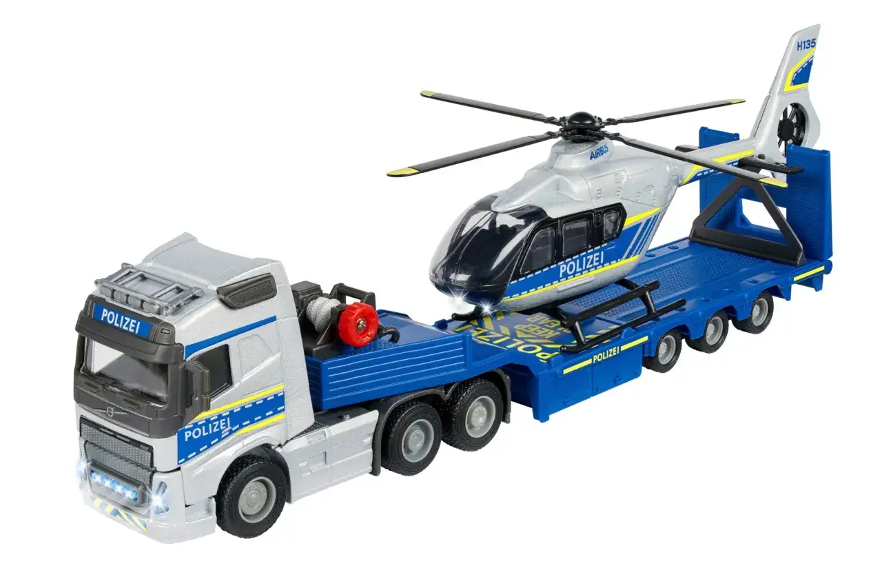 Polisens helikopter lastbil &auml;r redo f&ouml;r uppdrag. En silverf&auml;rgad lastbil med bl&aring; trailer transporterar en silverf&auml;rgad polishelikopter.